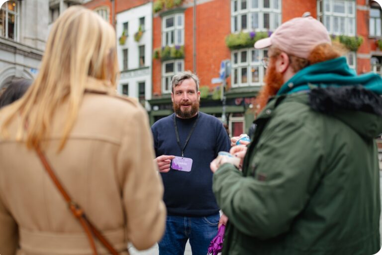 Tour Guide on the Free Tour of Dublin standing outside of famous Irish pub O'Neills talking to guests