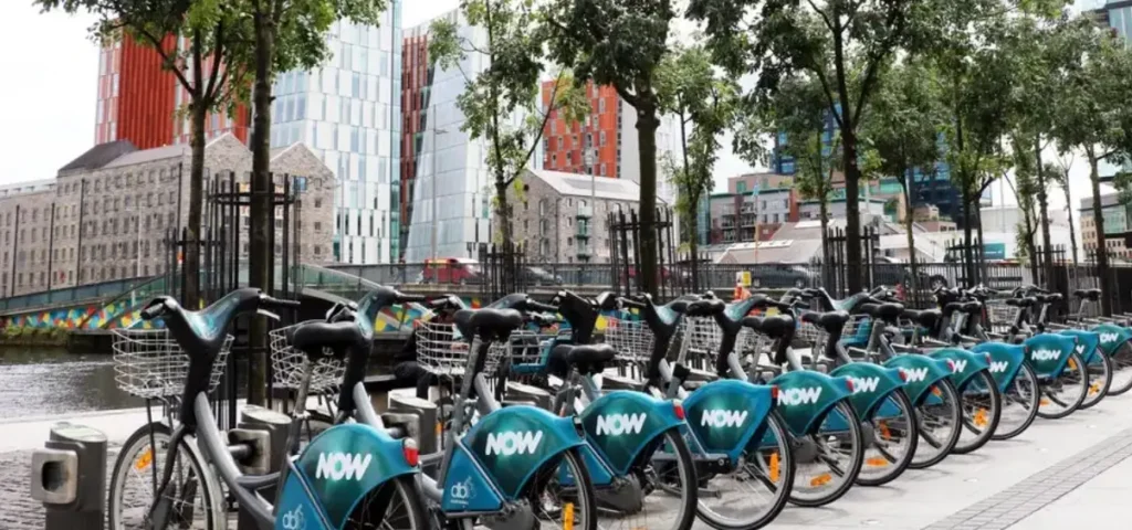 A parked rack of dublin bikes parked up on the quays full of bikes outside Customs House
