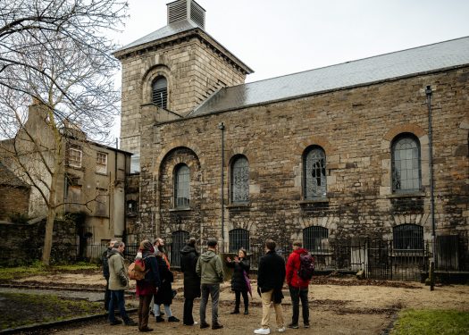 a tour group stands in front of st catherines church